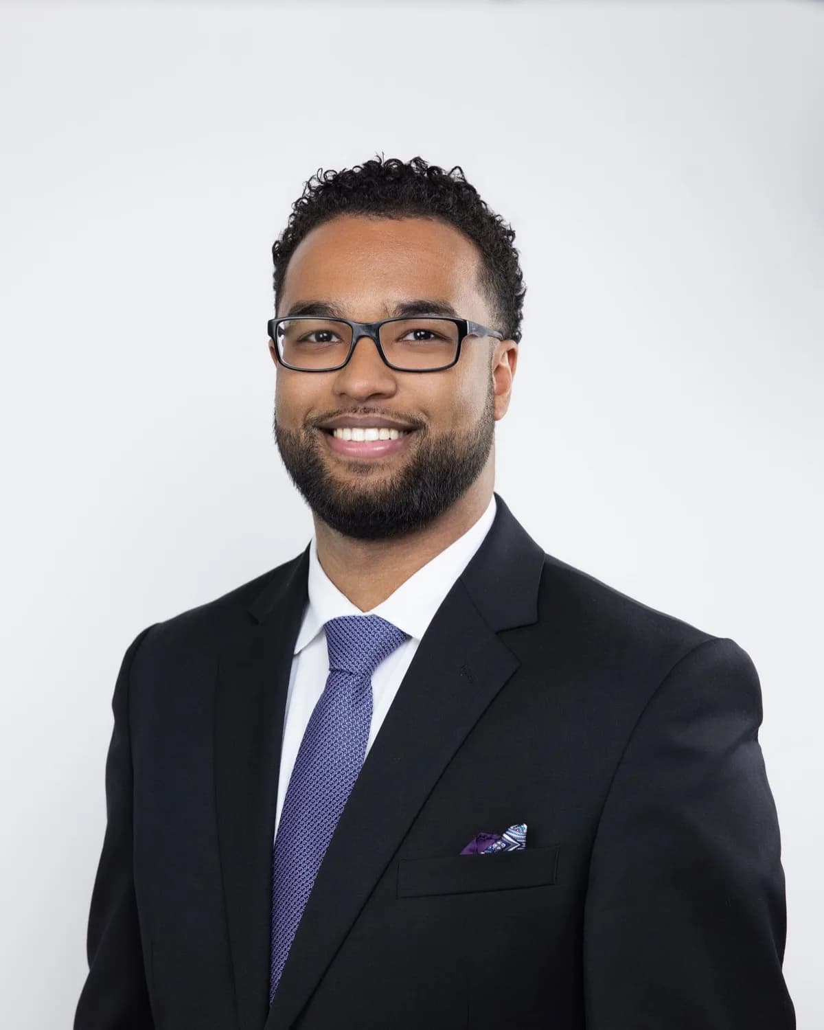 Executive headshot in dark suit and tie — corporate portrait by Omilia Visuals, Toronto